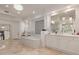Elegant bathroom with a crystal chandelier, tub, double vanity, and glass block window at 10534 N 133Rd St, Scottsdale, AZ 85259