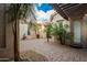 Charming courtyard featuring lush landscaping, a stone fountain, and a welcoming entrance, offering privacy at 10534 N 133Rd St, Scottsdale, AZ 85259