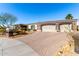 Attractive home features an expansive brick driveway, desert landscaping, and a convenient two-car garage at 10534 N 133Rd St, Scottsdale, AZ 85259