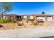 Charming home featuring a desert landscape with a two car garage and a red tile roof under a bright blue sky at 10534 N 133Rd St, Scottsdale, AZ 85259