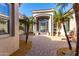 Elegant front entrance boasting ironwork door and manicured landscaping, complemented by brick pathway at 10534 N 133Rd St, Scottsdale, AZ 85259