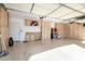 Well-organized three-car garage featuring ample cabinet space and epoxy flooring at 10534 N 133Rd St, Scottsdale, AZ 85259