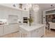 Bright kitchen with stainless appliances, an island with seating, and white cabinets for a classic look at 10534 N 133Rd St, Scottsdale, AZ 85259
