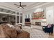Spacious living room with a stone fireplace, large windows, and comfortable seating at 10534 N 133Rd St, Scottsdale, AZ 85259