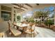 Covered outdoor patio area featuring wood beams and an outdoor dining set near pool at 10534 N 133Rd St, Scottsdale, AZ 85259