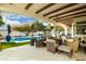 Spacious covered patio with comfortable seating, heaters, and pool views, perfect for outdoor living at 10534 N 133Rd St, Scottsdale, AZ 85259