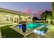 Outdoor pool and patio area at dusk with large blue decorative vase and mountain views at 10534 N 133Rd St, Scottsdale, AZ 85259