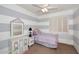 Charming bedroom with playful stripe accent wall, plantation shutters, and decorative furnishings at 10572 E Tierra Buena Ln, Scottsdale, AZ 85255