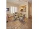 Bright dining area features modern lighting, plantation shutters, and an open view to the kitchen at 10572 E Tierra Buena Ln, Scottsdale, AZ 85255