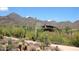 Scenic view of a modern home surrounded by desert landscaping and mountains in the background at 10572 E Tierra Buena Ln, Scottsdale, AZ 85255