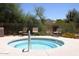 Community hot tub with seating, set against a backdrop of lush greenery and a distant mountain at 10572 E Tierra Buena Ln, Scottsdale, AZ 85255