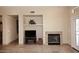Cozy living room with a fireplace, built-in shelving, and travertine floors at 10572 E Tierra Buena Ln, Scottsdale, AZ 85255
