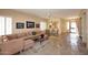 Spacious living room boasts tile flooring, a comfortable sofa, and seamless flow to the dining area and kitchen at 10572 E Tierra Buena Ln, Scottsdale, AZ 85255