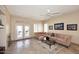 Comfortable living room boasts travertine floors, ceiling fan and access to outdoor living at 10572 E Tierra Buena Ln, Scottsdale, AZ 85255