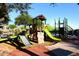 Community playground featuring slides, climbing structures, and soft landing surfaces for safety at 10572 E Tierra Buena Ln, Scottsdale, AZ 85255