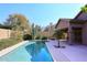 Inviting backyard pool with desert landscaping and a covered patio area, perfect for relaxation and outdoor enjoyment at 10572 E Tierra Buena Ln, Scottsdale, AZ 85255
