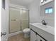 Bright bathroom with a shower over tub, modern vanity and sliding door, and tile floors at 11020 N 45Th Ave, Glendale, AZ 85304