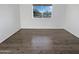 Bright bedroom with modern flooring and a large window, offering a view of the outdoors and ample natural light at 11020 N 45Th Ave, Glendale, AZ 85304