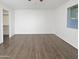 Empty bedroom with wood-look floors, walk-in closet, and natural light at 11020 N 45Th Ave, Glendale, AZ 85304