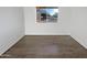 Empty room with hard floors and a bright window that faces the street with a tree at 11020 N 45Th Ave, Glendale, AZ 85304