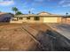 Charming single-story home with xeriscaped front yard, attached garage, and blue sky at 11020 N 45Th Ave, Glendale, AZ 85304