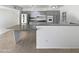Bright kitchen with stainless steel appliances, light gray cabinets, tile floors, and eat-in counter at 11020 N 45Th Ave, Glendale, AZ 85304