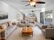 Bright living room with a gray sofa set, plush rug, and a view into the modern kitchen at 11020 N 45Th Ave, Glendale, AZ 85304