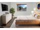 Bright main bedroom with a queen bed, white dresser, rug, and a view to the street at 11020 N 45Th Ave, Glendale, AZ 85304