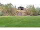Backyard hillside with desert landscaping and a private gate at 1127 N Sherwood Way, Queen Valley, AZ 85118