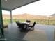 Outdoor deck featuring a dining set and a scenic view of the mountains at 1127 N Sherwood Way, Queen Valley, AZ 85118