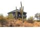 Hillside home surrounded by desert landscape and mature saguaro cacti at 1127 N Sherwood Way, Queen Valley, AZ 85118