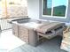 Outdoor hot tub featuring a deck, stone accents, and relaxing space at 1127 N Sherwood Way, Queen Valley, AZ 85118