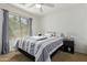 Bedroom with neutral decor, large window, ceiling fan and carpeted floors that enhance a cozy vibe at 12363 W Mohave St, Avondale, AZ 85323