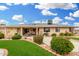 Beautifully landscaped backyard with a patio and well-maintained shrubs and trees at 12403 W Allegro Dr, Sun City West, AZ 85375