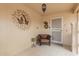 Inviting entryway with neutral tiled floor, cozy chair, and decorative wall art creates a warm welcome at 12403 W Allegro Dr, Sun City West, AZ 85375