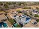 Expansive aerial view of homes with solar panels in a green residential neighborhood with community park at 12956 N 152Nd Ave, Surprise, AZ 85379