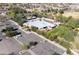 Aerial view of community center with pool, covered outdoor areas, parking and green spaces at 12956 N 152Nd Ave, Surprise, AZ 85379