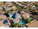 Wide aerial shot showcasing home with pool, solar panels, and neighborhood at 12956 N 152Nd Ave, Surprise, AZ 85379