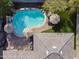 Aerial shot of backyard pool with lounge seating and outdoor umbrellas near patio with trees at 12956 N 152Nd Ave, Surprise, AZ 85379