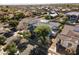 Wide aerial shot showcasing home with solar panels, lush landscaping, and nearby street at 12956 N 152Nd Ave, Surprise, AZ 85379