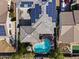 Overhead aerial view of a home with solar panels, an outdoor patio, and a sparkling swimming pool at 12956 N 152Nd Ave, Surprise, AZ 85379