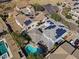 High aerial view of home featuring solar panels, a backyard pool and patio in a residential area at 12956 N 152Nd Ave, Surprise, AZ 85379