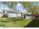 Spacious backyard with artificial turf, pool, and lounge area, ideal for entertaining at 12956 N 152Nd Ave, Surprise, AZ 85379