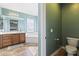 Bright bathroom with a large vanity, soaking tub, and tiled floors, exuding a spa-like ambiance at 12956 N 152Nd Ave, Surprise, AZ 85379