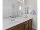 Bathroom vanity features double sinks, white countertops, and a large mirror at 12956 N 152Nd Ave, Surprise, AZ 85379
