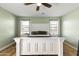 This bedroom features light green walls, a ceiling fan, and a white bed frame with light-colored wood floors at 12956 N 152Nd Ave, Surprise, AZ 85379