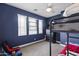 Stylish bedroom with bold blue walls, a ceiling fan, and a bunk bed with space for relaxation at 12956 N 152Nd Ave, Surprise, AZ 85379