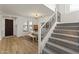 Bright entryway with staircase, a stylish chandelier, wood-look floors, and contemporary decor at 12956 N 152Nd Ave, Surprise, AZ 85379