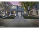 Inviting two-story home featuring a porte-cochere, desert landscaping, and a welcoming front porch at 12956 N 152Nd Ave, Surprise, AZ 85379
