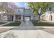 Attractive two-story home with a porte-cochere, fresh landscaping, and a charming front porch at 12956 N 152Nd Ave, Surprise, AZ 85379